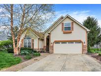 Charming home featuring a two-car garage, brick accents, and fresh landscaping at 13841 Waywing Ct, Carmel, IN 46033