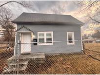 Charming single-story home with gray siding, a modest front porch, and a fenced yard at 1425 W 9Th St, Anderson, IN 46016