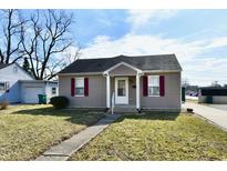 Charming single-story home featuring gray siding, a gray roof, and well-maintained landscaping at 1507 Park Dr, Lebanon, IN 46052