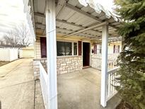 Inviting covered front porch with stone accents and access to the home's entrance at 2567 Harlan St, Indianapolis, IN 46203