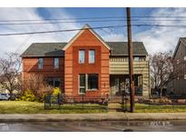 Charming two-story red brick home with a well-manicured front yard and inviting curb appeal at 304 E 17Th St, Indianapolis, IN 46202