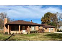 Charming brick home featuring a well-maintained lawn and mature trees at 316 Elm St, Greenwood, IN 46142