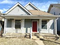 Charming home featuring a covered front porch and a striking red front door at 3426 W Michigan St, Indianapolis, IN 46222