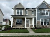 Charming two-story home with stone accents, covered porch, and manicured lawn at 3913 Wren Dr, Brownsburg, IN 46112