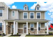 Charming two-story home with stone accents, covered porch, and white pillars at 3959 Wren Dr, Brownsburg, IN 46112