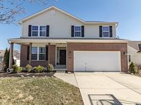 Two-story home with brick and siding exterior, black shutters, and a two-car garage at 4063 S Meadow Wood Ct, New Palestine, IN 46163