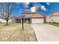 Charming two-story home with a brick and siding exterior and a well-manicured lawn at 455 Alton Dr, Greenwood, IN 46143