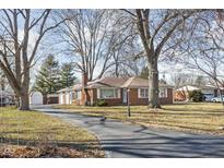 Charming single-story brick home with a large front yard and a long driveway at 4808 N Tuxedo St, Indianapolis, IN 46205
