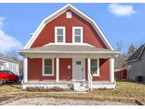 Charming two-story home with red siding, white trim, and a cozy covered front porch at 5334 E Burgess Ave, Indianapolis, IN 46219