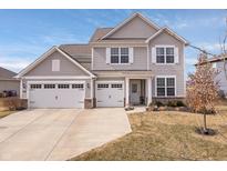Charming two-story home with a three-car garage and well-manicured lawn in a suburban neighborhood at 5646 Mahogany Dr, Noblesville, IN 46062