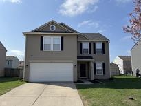 Charming two-story home featuring a two-car garage, gray siding, and manicured lawn on a sunny day at 785 Country Gate Dr, New Whiteland, IN 46184