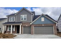Charming two-story home featuring brick and siding accents and an attached two-car garage at 828 Cowley Dr, Westfield, IN 46074