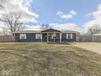 Charming single-story home boasts blue siding, white trim, and a well-maintained front yard at 912 Sweetbriar Ave, Whiteland, IN 46184