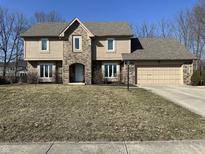 Charming two-story home featuring a two car garage and a well-manicured front lawn at 950 Nevelle Ln, Carmel, IN 46032