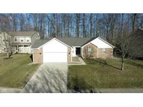 Charming single-story brick home featuring an attached two-car garage and a well-maintained front lawn at 17051 Rainier Cir, Westfield, IN 46062