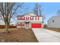Charming two-story home with red shutters and a bright red garage door provides curb appeal at 1750 Quiet Haven Cir, Indianapolis, IN 46229