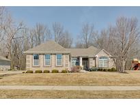 Charming single-story brick home with a well-maintained lawn and inviting entrance at 1824 Jutland Dr, Carmel, IN 46032