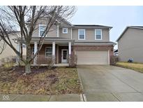 Two-story home with a brick and vinyl facade, attached two-car garage, and covered front porch at 2336 Boneset Dr, Plainfield, IN 46168