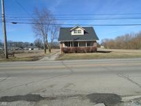 Charming single-story home featuring a brick foundation, front porch, and a dormer window at 2860 S Meridian St, Indianapolis, IN 46225