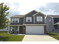 Charming two-story home featuring a manicured lawn, gray siding, white trim, and a two-car garage at 2913 W Broderie Ln, Monrovia, IN 46157