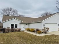 Charming single-story home with neutral siding, attached garage, and manicured landscaping at 3408 Village Dr, Anderson, IN 46011