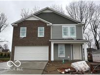 Charming two-story home featuring brick and gray siding, a two-car garage, and a welcoming front porch at 3825 Windstar Way, Columbus, IN 47203