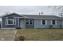 Charming one-story home featuring a blue exterior, bay window, and well-maintained front yard at 416 Sayre Dr, Greenwood, IN 46143