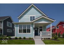 Charming two-story home with light blue siding, a cozy front porch, and well-maintained landscaping at 5421 Upper Garden Way, Zionsville, IN 46077