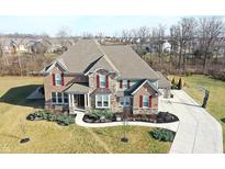 Beautiful two-story brick home with manicured landscaping and a long driveway at 5683 Oakmont Blvd, Bargersville, IN 46106