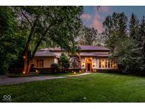 Elegant home featuring lush green lawn, manicured landscaping, and warm exterior lighting at 5977 S 800 E, Zionsville, IN 46077