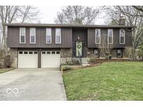 Inviting two-story home with a well-maintained lawn, attached two-car garage, and beautiful landscaping at 615 Shady Creek Dr, Greenwood, IN 46142