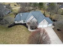 Beautiful aerial view of a brick home with a three-car garage and a spacious driveway at 7472 Windridge Way, Brownsburg, IN 46112
