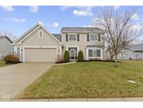 Traditional two-story home with a manicured lawn, attached two-car garage, and inviting front entryway at 7591 Meadow Ridge Dr, Fishers, IN 46038