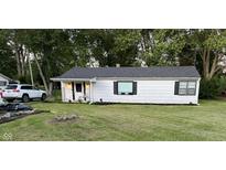 Charming single-story home with fresh landscaping and an inviting, well-manicured front lawn at 9909 N 125 W, Fortville, IN 46040