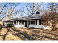 Charming single-story home with a well-maintained lawn and mature trees in a quiet neighborhood at 1020 E 51St St, Indianapolis, IN 46205