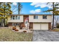 Charming two-story home with brick accents, an American flag and a two car garage at 1218 W Shady Creek Dr, Greenwood, IN 46142