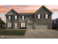 Inviting two-story home featuring a brick and siding exterior with an attached two car garage at 1395 Labrot Ct, Avon, IN 46123