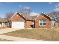 Charming single-story brick home with a two-car garage and a well-maintained front yard at 160 Tracy Ridge Blvd, Whiteland, IN 46184