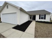 Charming single-story home featuring an attached garage and well-maintained landscaping at 2399 Orchard Creek Dr, Columbus, IN 47201
