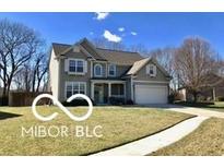 Charming two-story home with a well-manicured lawn and attached two car garage at 3258 Starlite Ct, Columbus, IN 47203