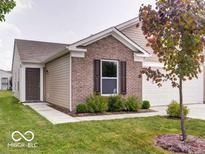 Charming home featuring a brick facade, complemented by lush green lawn and landscaping at 3693 Berkdale Dr, Columbus, IN 47203
