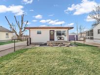 Charming single-story home with a well-manicured lawn, featuring a cozy front porch and complementary yard decor at 4592 Gordon Dr, Plainfield, IN 46168