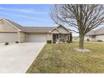 Well-manicured lawn featuring a brick home and trimmed landscaping at 6103 Lazy Ln, Indianapolis, IN 46259