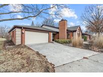 Charming brick home featuring a two-car garage and well-maintained landscaping at 9277 Golden Leaf Way, Indianapolis, IN 46260