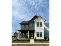Two-story home featuring a dark green and white color scheme, landscaped yard, and a welcoming front porch at 9868 Bucklebury Ln, Carmel, IN 46280