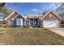 Charming home boasts blue siding, brick accents, and a well-manicured front lawn at 10556 Marlin Ct, Indianapolis, IN 46256