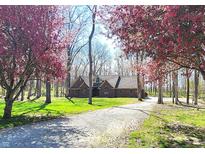 Charming brick home with lush trees and a long, inviting driveway in a tranquil setting at 1285 W Judson Ln, Mooresville, IN 46158