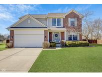 Charming two-story home with a brick and siding exterior, complemented by a well-manicured lawn and landscaping at 14126 Secretariat Ct, Carmel, IN 46074