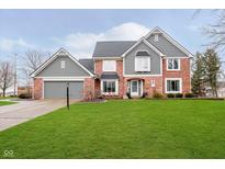 Charming two-story home featuring brick and gray siding, with a well-manicured lawn at 14809 Adios Pass, Carmel, IN 46032