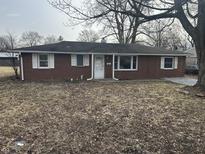 Charming one-story brick home featuring a well-maintained front yard and inviting entrance at 2032 Costello Dr, Anderson, IN 46011